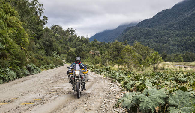 Man driving on a touring motorbike gravel road on  Carretera Austral — Stock Photo