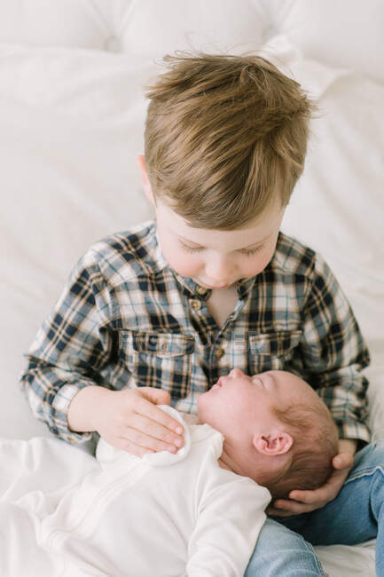 Big brother holding his baby sister for first time — Stock Photo
