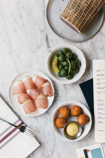 Restaurant bistro table full of savory appetizers and Italian foods — Stock Photo