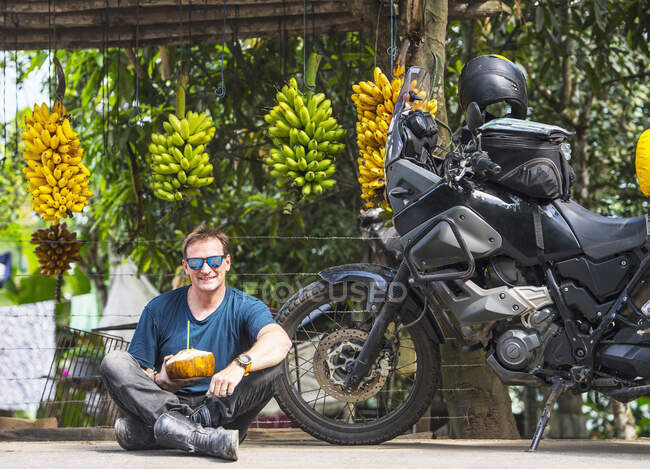 Cavalier de moto appréciant les fruits locaux, Machala, El Oro, Équateur — Photo de stock