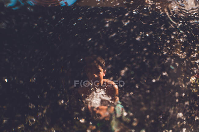 Water hose fun, spraying at a window — Stock Photo