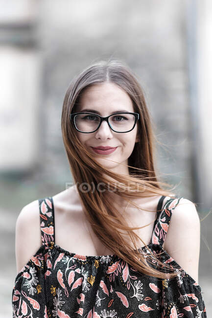Young brown-haired millennial with glasses and light dress — Stock Photo