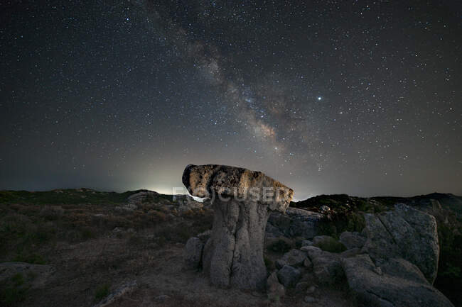 Milky way panorama above a mushroom-shaped rock — Stock Photo