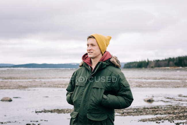 Portrait of a man smiling whilst standing alone in the great outdoors — Stock Photo
