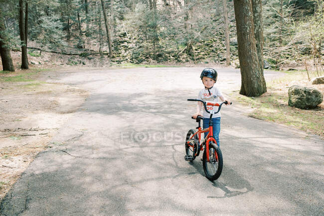 Маленький хлопчик вчиться їздити на своєму велосипеді без тренувальних коліс . — стокове фото