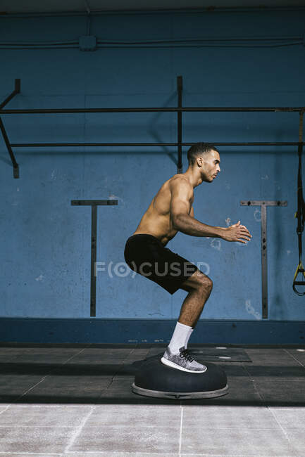 Athlète afro-américain masculin faisant de l'exercice au gymnase — Photo de stock