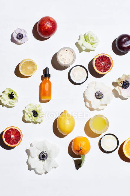 Top view of fresh fruits and cosmetic products  on white background — Stock Photo