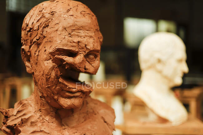 Destructed clay head in art studio — Stock Photo