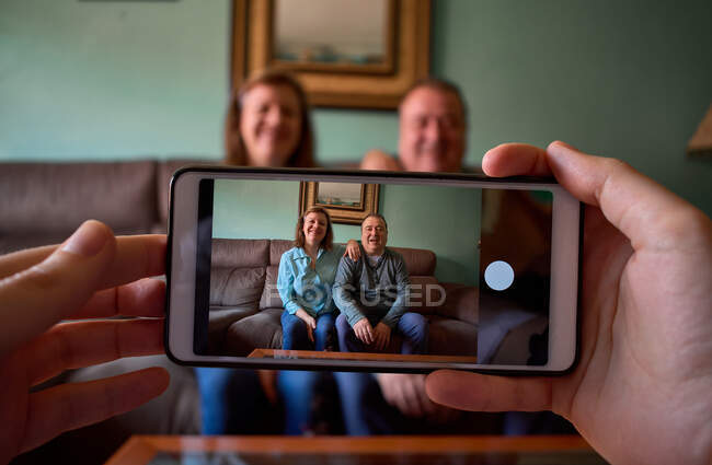 Couple d'âge moyen pose et sourit pour une photo à la maison — Photo de stock