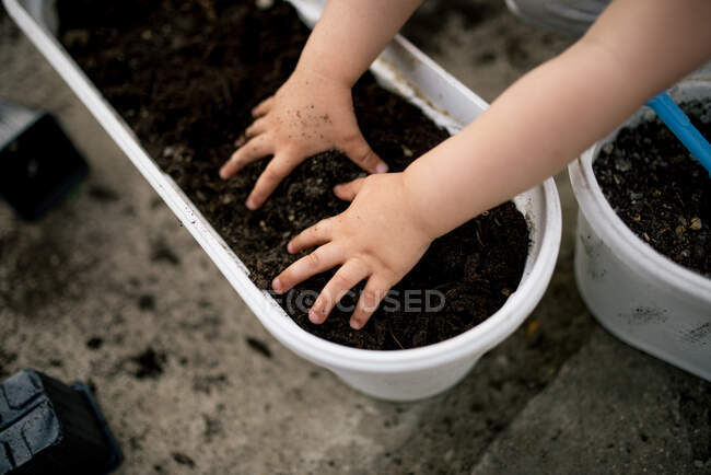 Petite fille avec de la terre dans le jardin en arrière-plan, gros plan — Photo de stock
