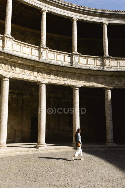 Eine junge Frau spaziert durch den Hof des Palastes Charles V, Granada — Stockfoto