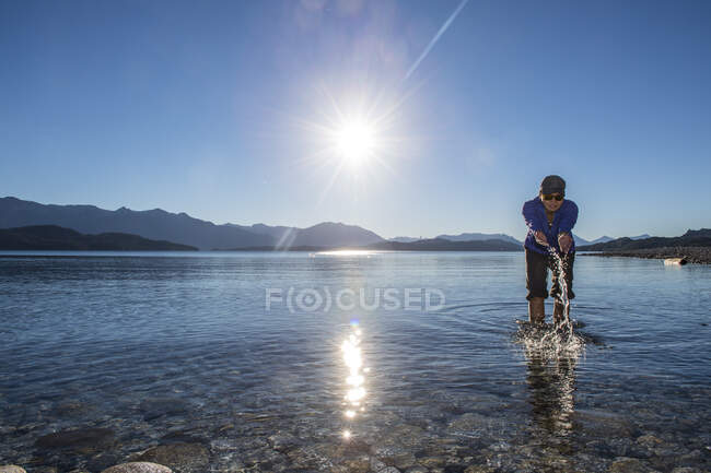 Woman trying the water at Nahuel Huapi Lake in Patagonia — Stock Photo