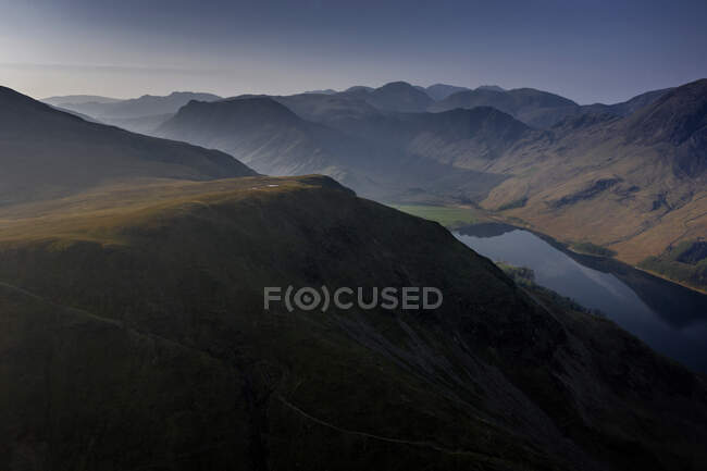Drone View over High Snockrigg Fell of Buttermere, the lake in the English Lake District in North West England. The adjacent village of Buttermere takes its name from the lake. Historically in Cumberland, the lake is now within the county of Cumbria. — Stock Photo