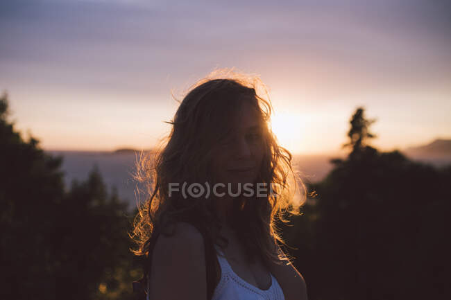 Portrait of young woman at sunset — Stock Photo