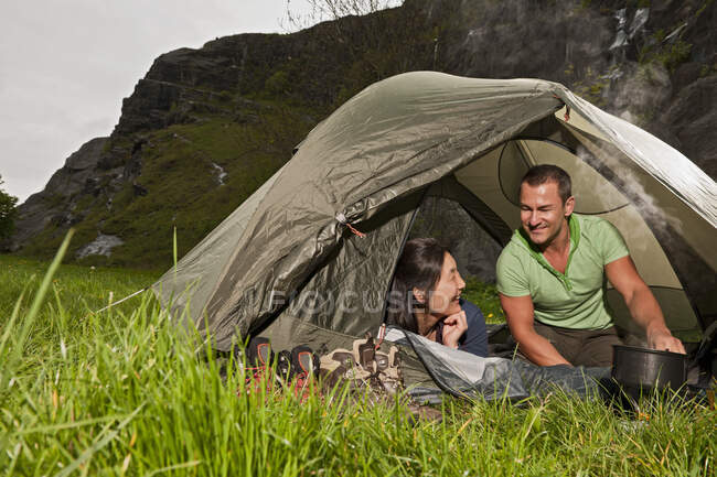 Mature couple cooking in tent in the UK — Stock Photo