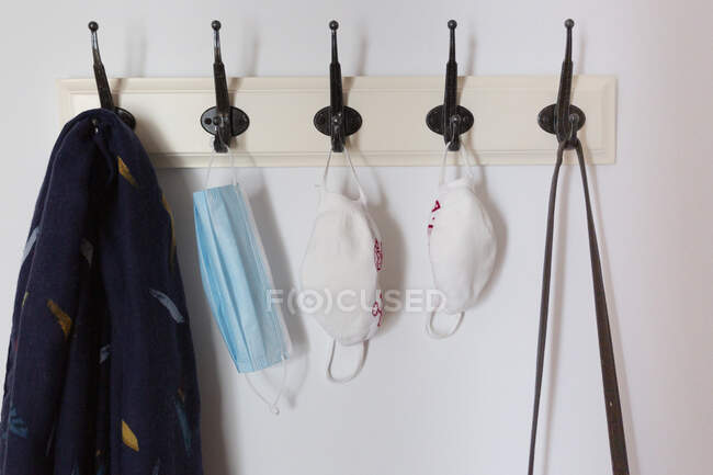 Still life three face masks and hanging from a coat rack — Stock Photo