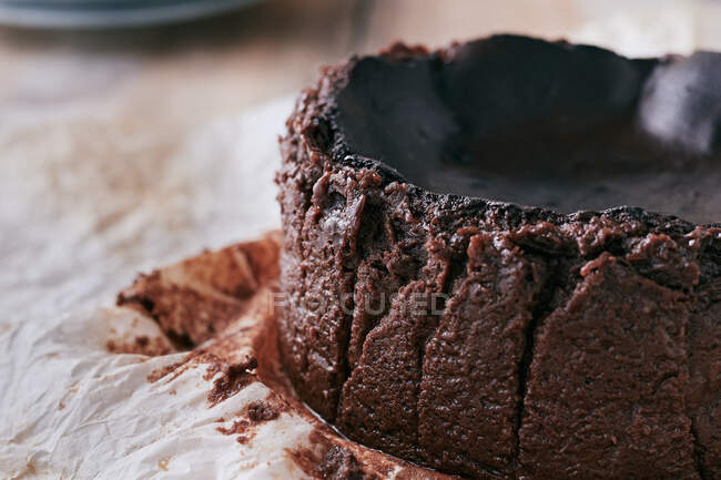 Close up of a chocolate basque burnt cheesecake on a wooden table — Stock Photo