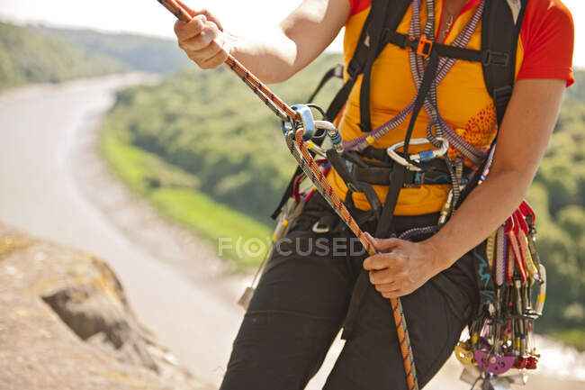 Close up of woman rappelling of cliff in south Wales — Stock Photo
