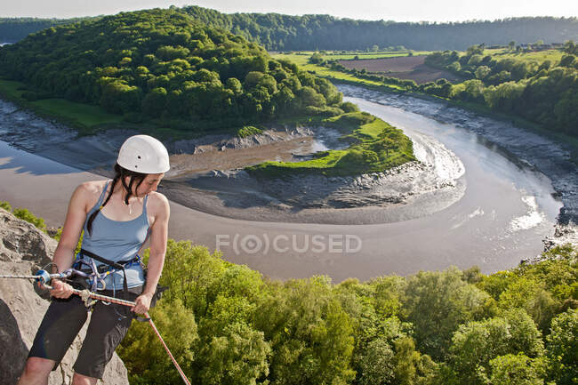 Woman rappelling of cliff in south Wales — Stock Photo