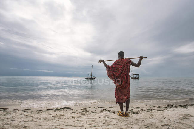 Homem com mochila na praia — Fotografia de Stock