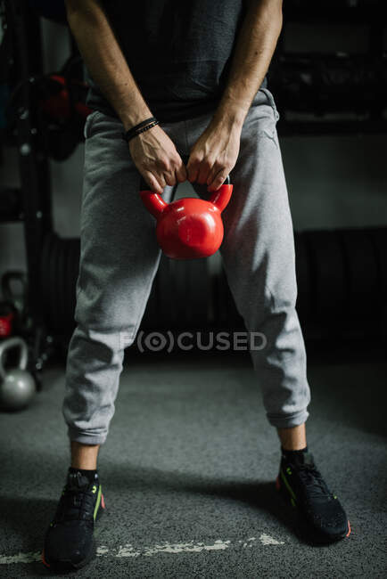 Attractive young athlete doing workout with kettlebell — Stock Photo