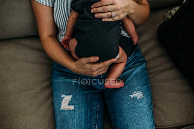 Sobrecarga de mulher segurando um bebê recém-nascido — Fotografia de Stock