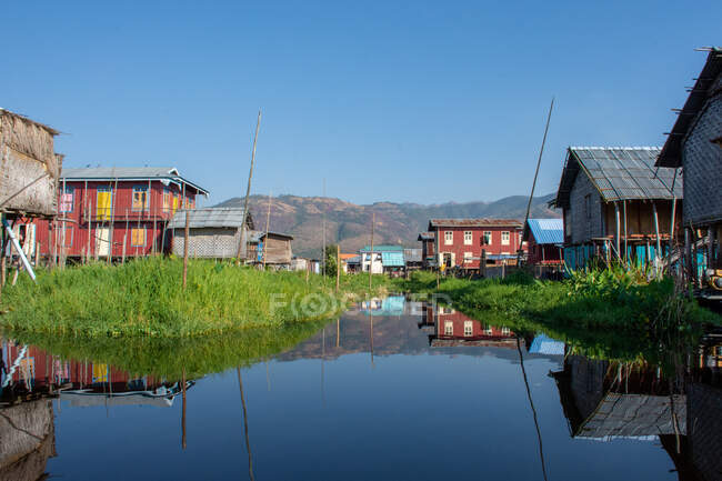 Местная деревня и ее отражения на озере — стоковое фото