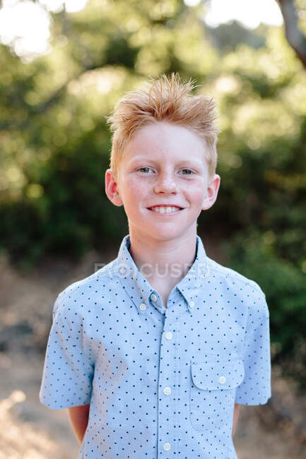 A Cute Red Haired Boy With Freckles Smiles For A Portrait Outside — Stock Photo