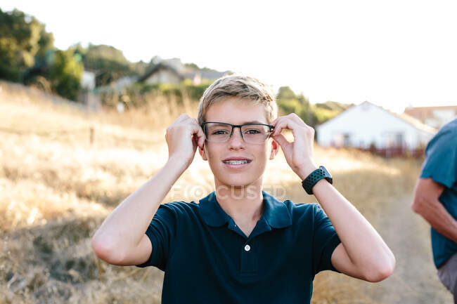 Portrait Of A Teen Boy With Braces Trying On His Dad's Eyeglasses — Stock Photo