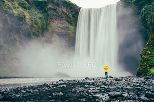 Beautiful waterfall in the mountains and woman — Stock Photo
