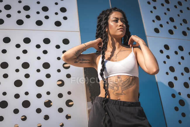 Young girl with tattoos, with nice background looking to the right — Stock Photo