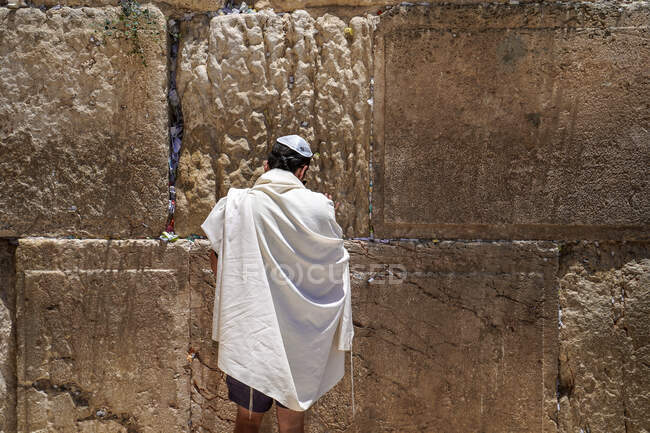 A man is praying in front of the Western Wall, Jerusalem, Israel — Stock Photo