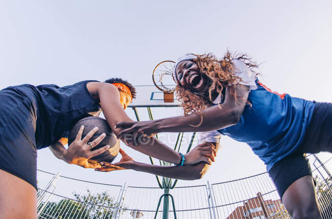 Латинские и африканские женщины играют в баскетбол — стоковое фото