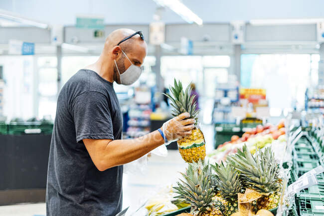 Uomo che acquista frutta fresca al supermercato — Foto stock