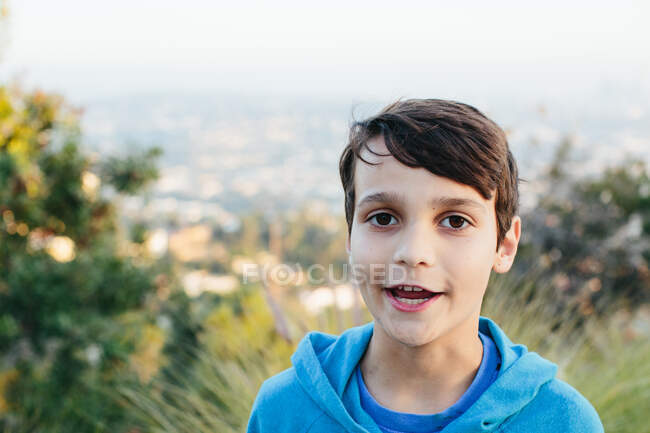 Portrait of a ten year old boy at a scenic overlook while he speaks — Stock Photo