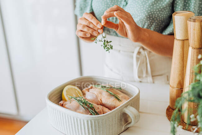 Female hands holding thyme for seasoning food — Stock Photo