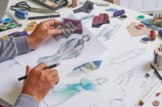 Fashion designer sketching costume design — Stock Photo