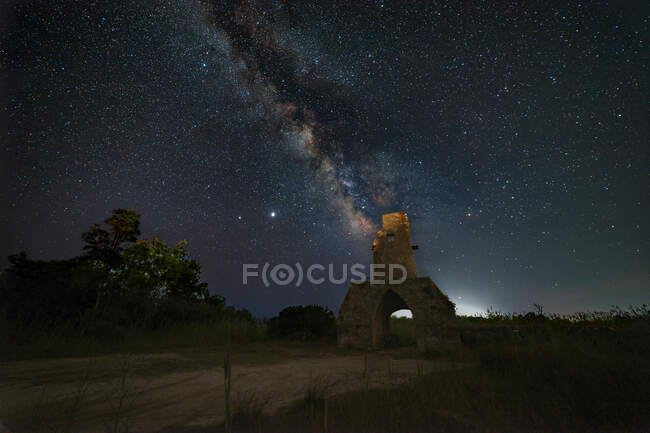 Panorama of an old tower during a starry night with the milky way — Stock Photo