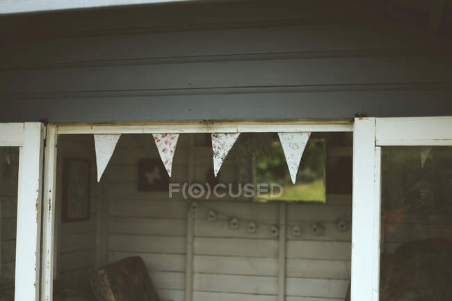 Pretty bunting hanging from a blue summer house — Stock Photo