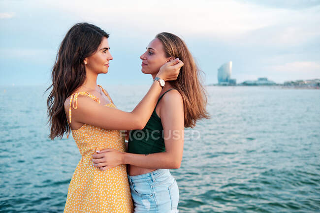 Ein paar lesbische Mädchen an einem Sommertag am Strand von Barcelona — Stockfoto