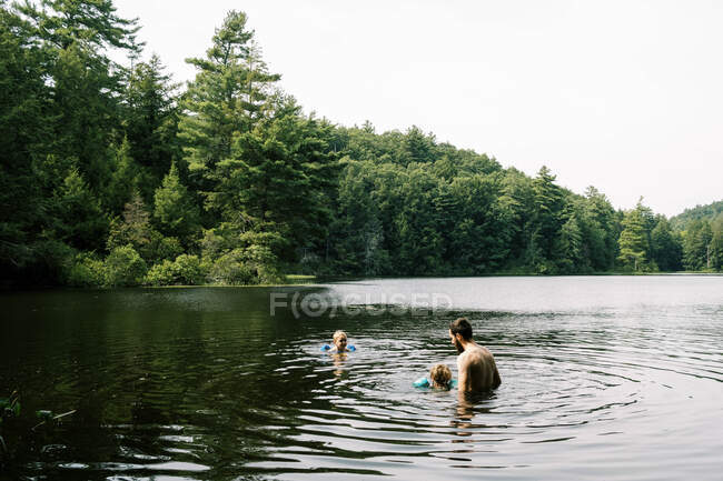 Un padre e i suoi figli si rinfrescano in una piscina nascosta — Foto stock
