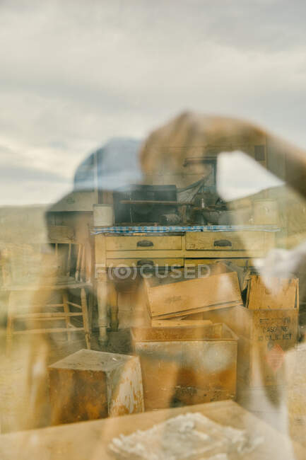 Young woman taking a self portrait in a window in northern California. — Stock Photo