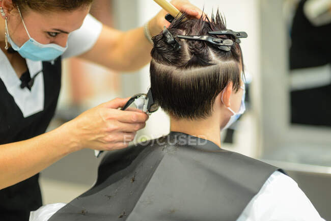 Young attractive female in beauty salon cutting styling and red — Stock Photo