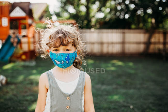 Cute little girl wearing face mask — Stock Photo