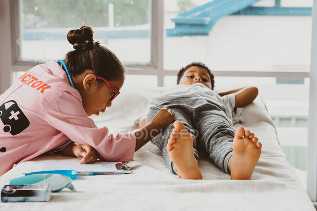 Childhood roleplay as doctor and patient — Stock Photo