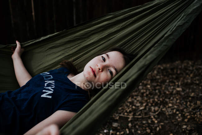 Preteen girl laying in hammock outside — Stock Photo