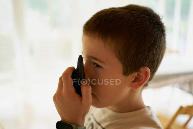 Boy talking on radio of summer park and playing — Stock Photo