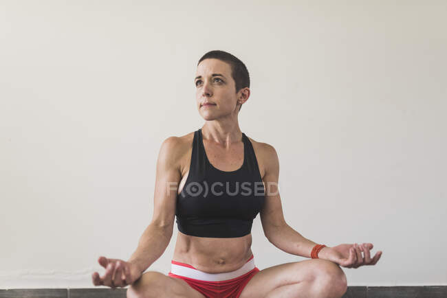Woman training and stretching indoors — Stock Photo