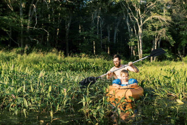 Un père et son fils explorant un marais en kayak — Photo de stock