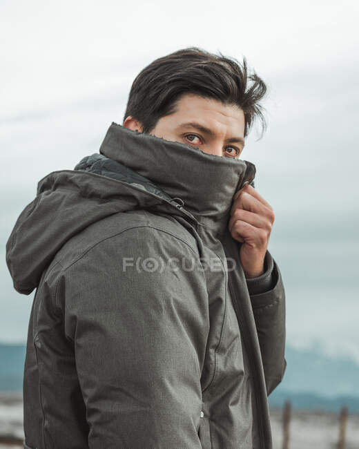 Portrait of young man covering his face — Stock Photo